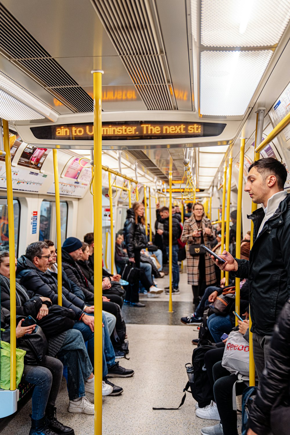 a group of people sitting on a subway train