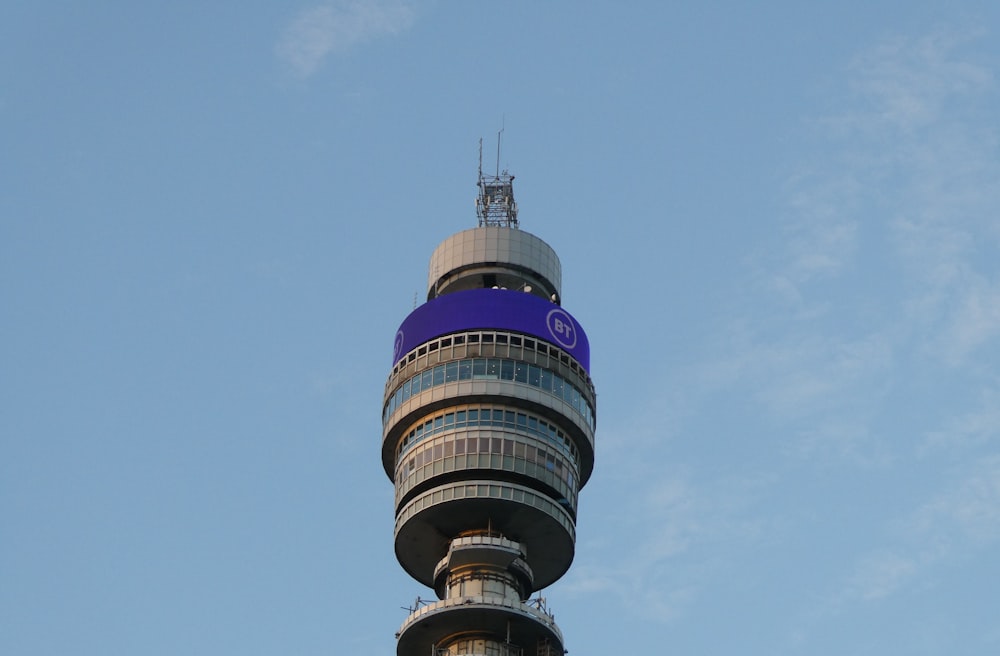 a very tall tower with a blue sign on it's side