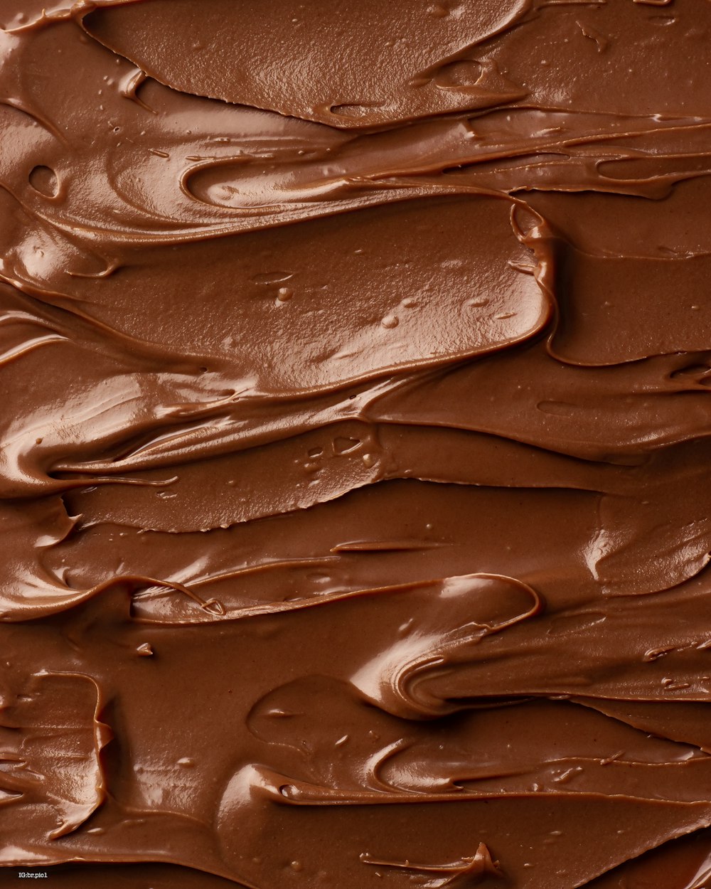 a close up of a cake with chocolate frosting