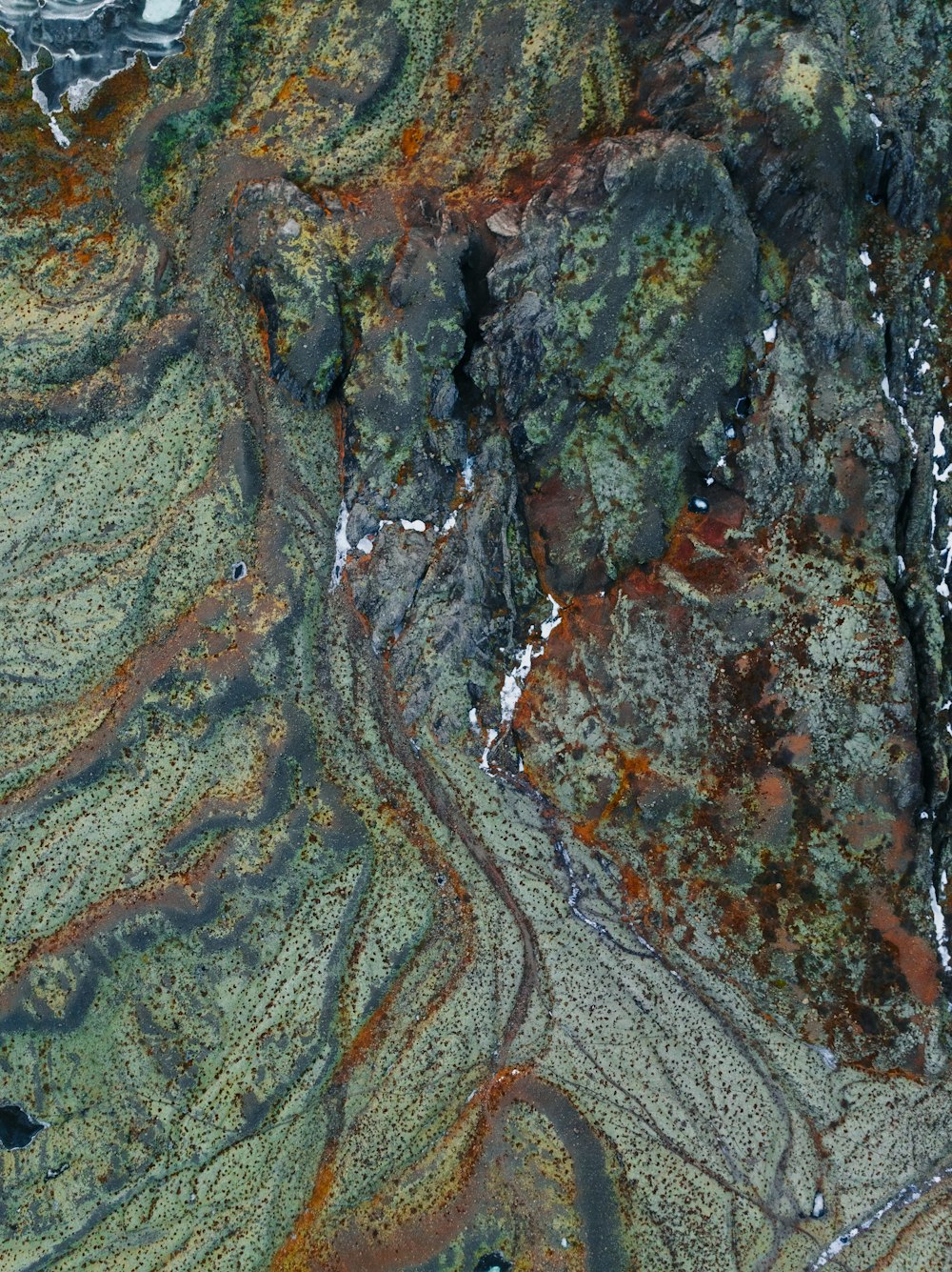 an aerial view of a mountain with a river running through it