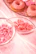 Close-up of beautifully arranged party sweets and decorations in pink, blue, and white tones.