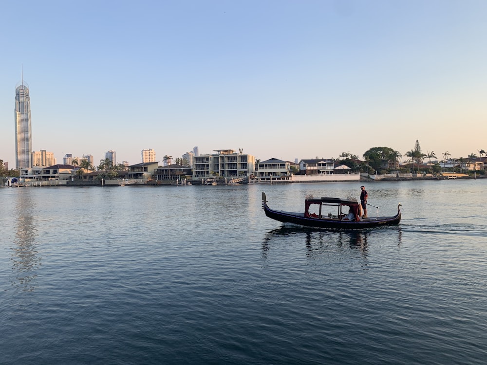 a man in a small boat on a large body of water