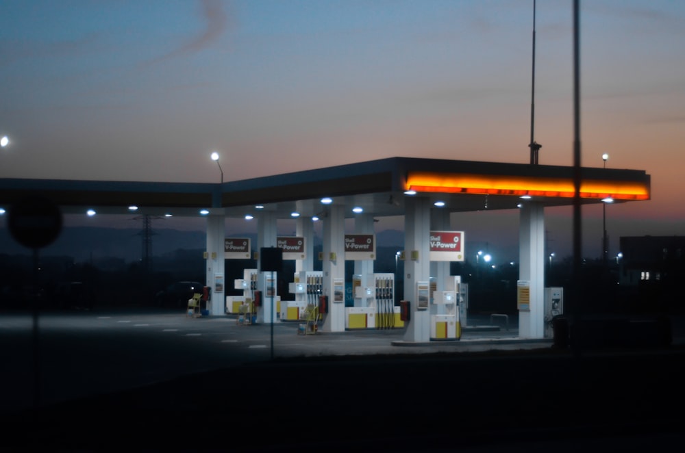 a gas station at night with the lights on