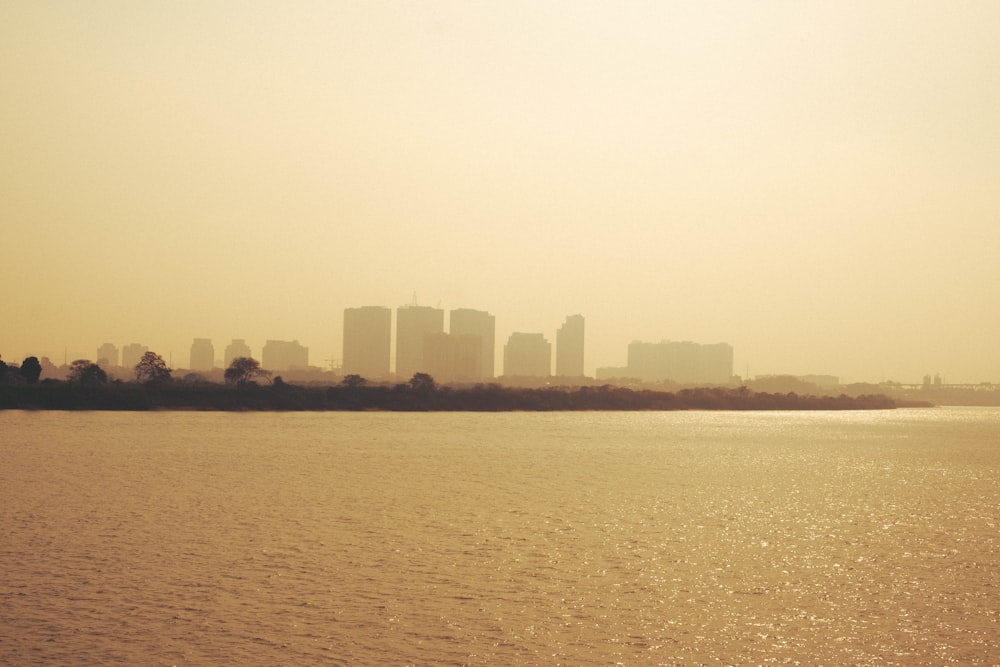 a large body of water with a city in the background