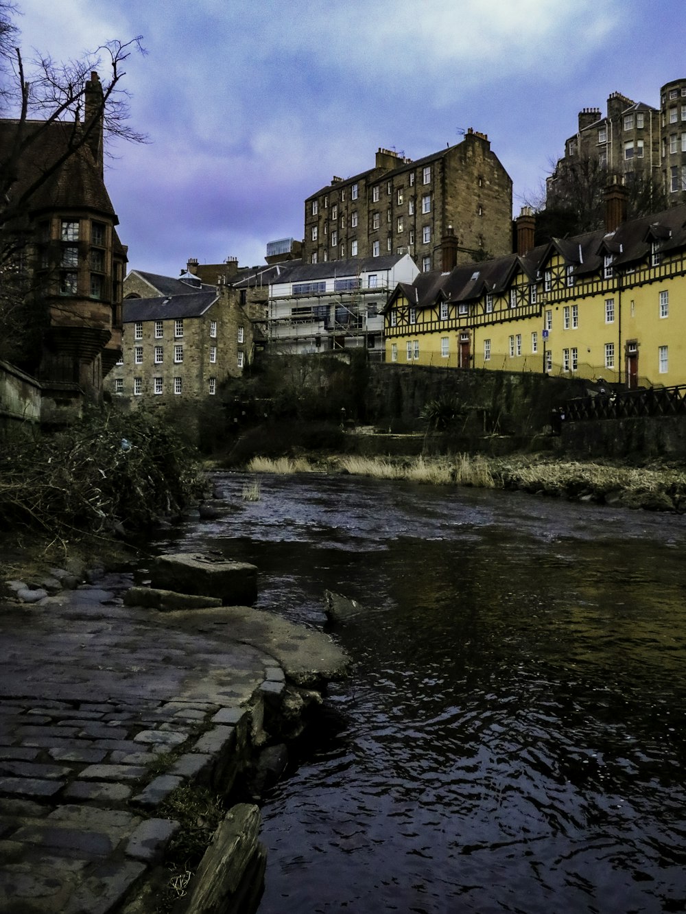 a river running through a city next to tall buildings