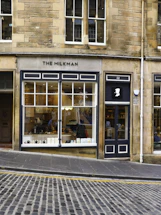 A cozy storefront with a welcoming sign reading 'casein ltd' in a bustling London street.