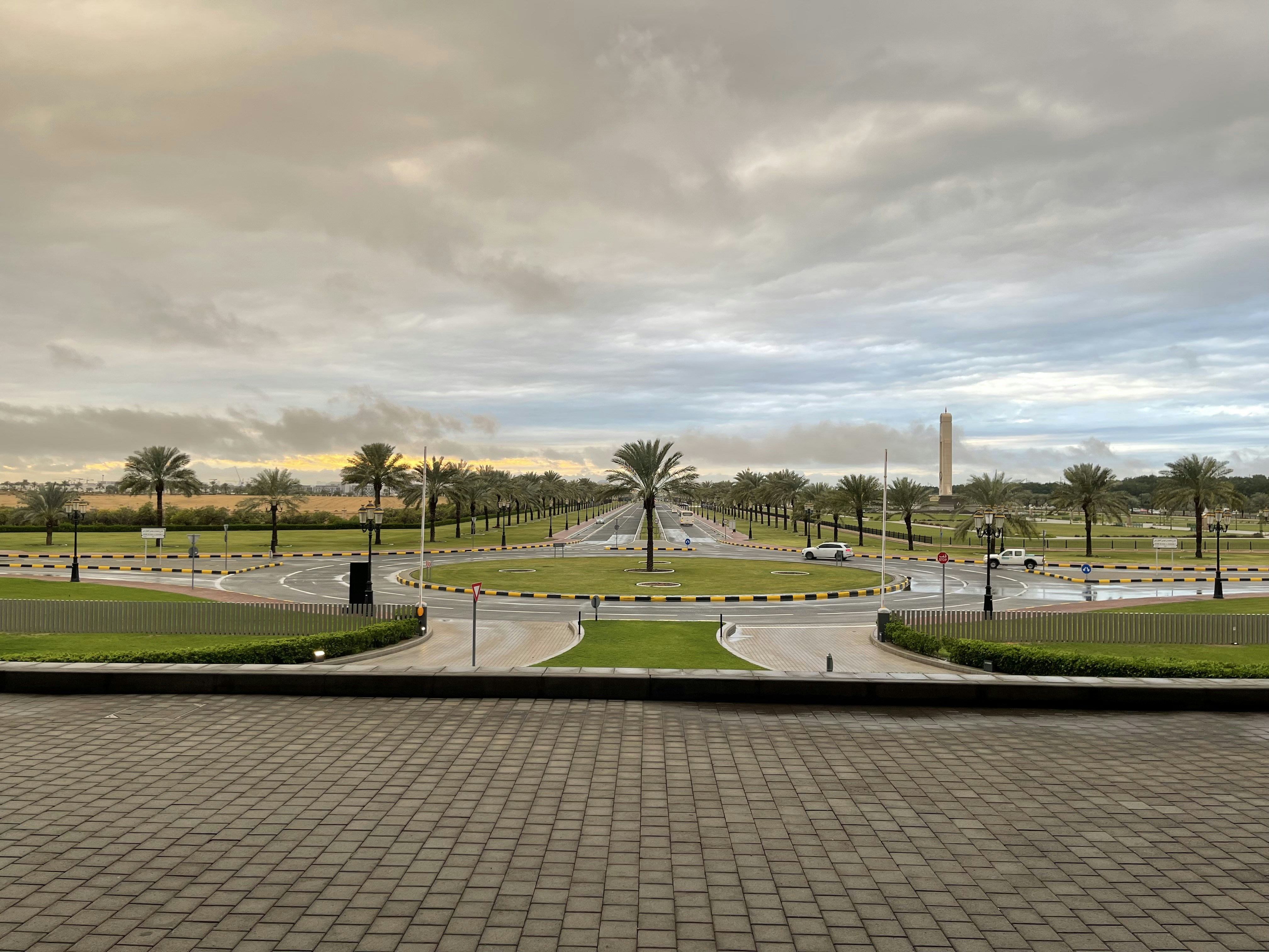 a view of a street with a fountain in the middle of it