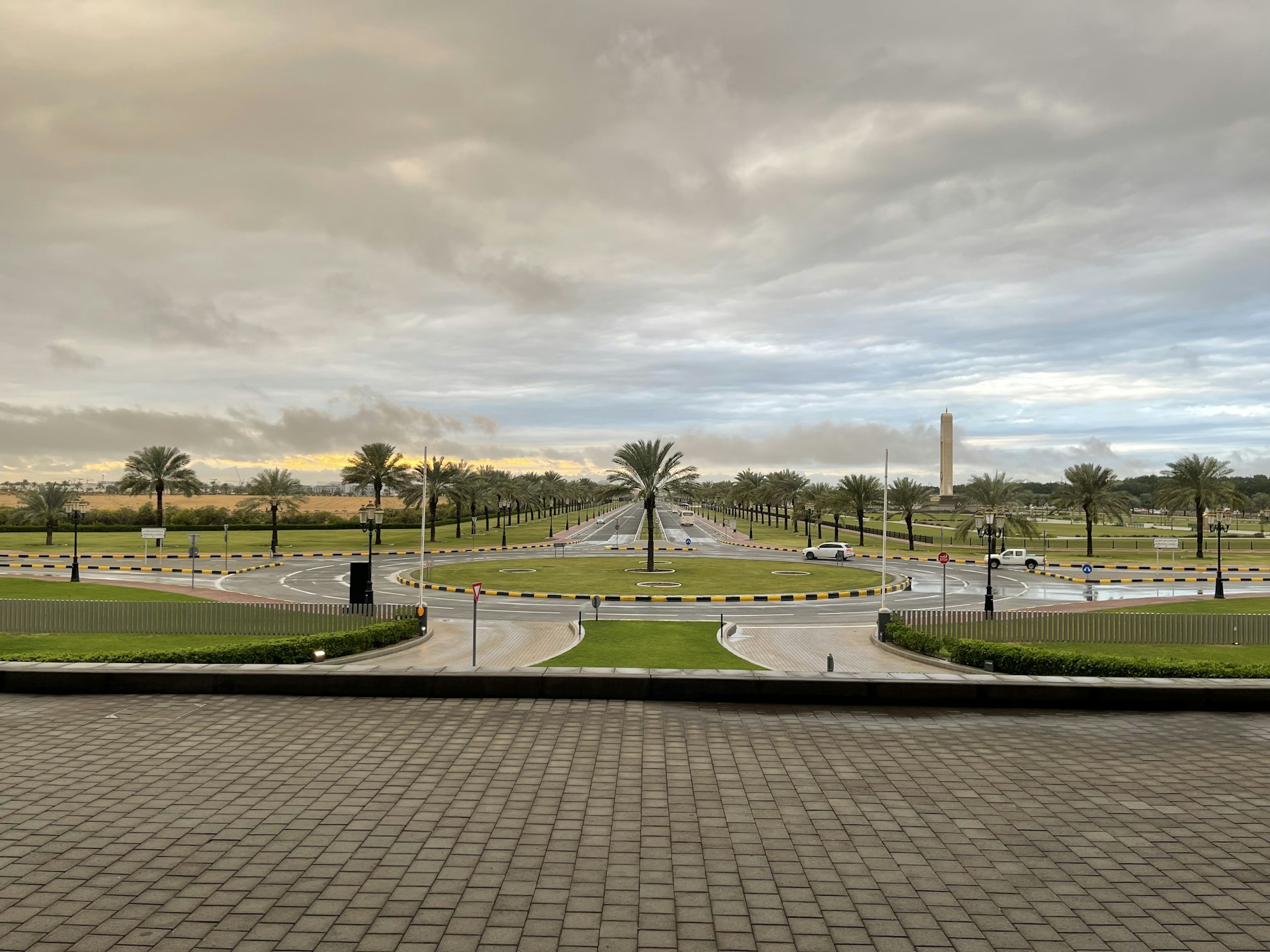 a view of a street with a fountain in the middle of it