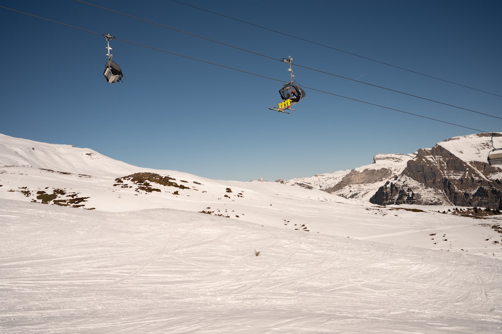 a ski lift carrying skiers up a snowy mountain
