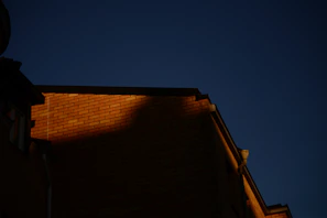 Hotel facade adorned with premium natural clay brick elevation tiles under soft evening light