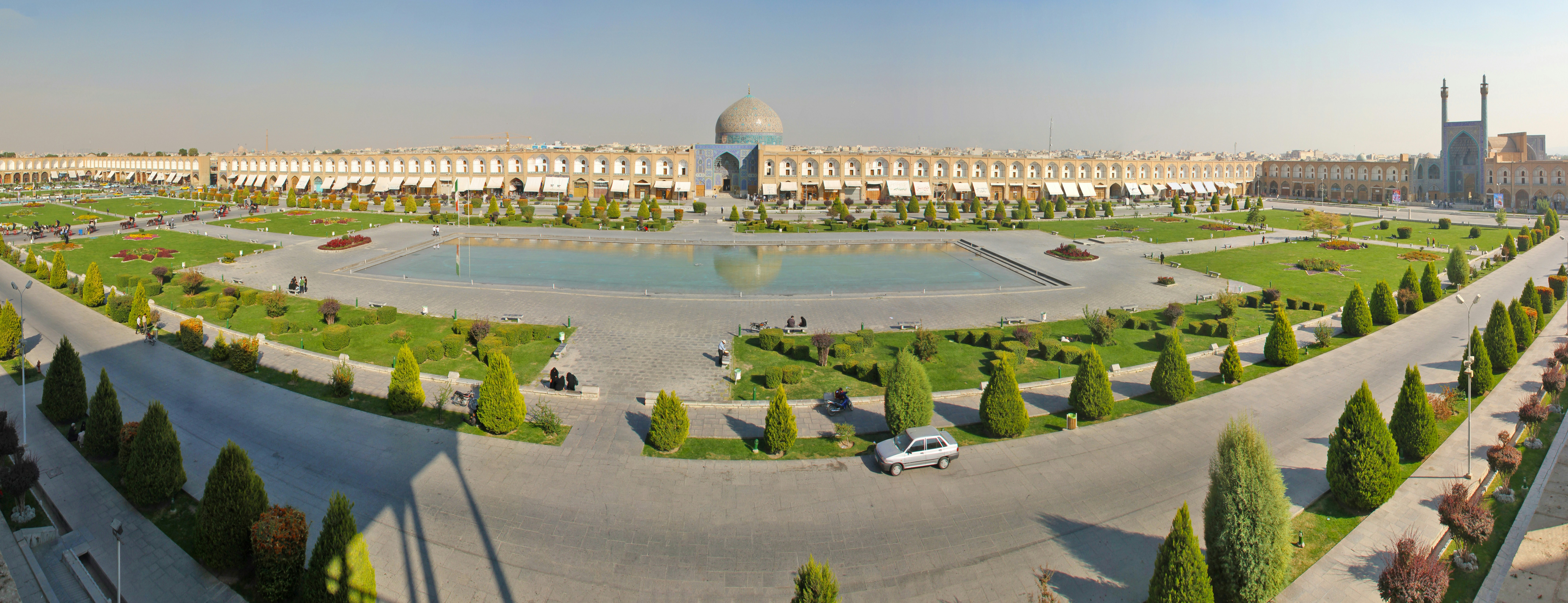 an aerial view of a park with a fountain in the middle