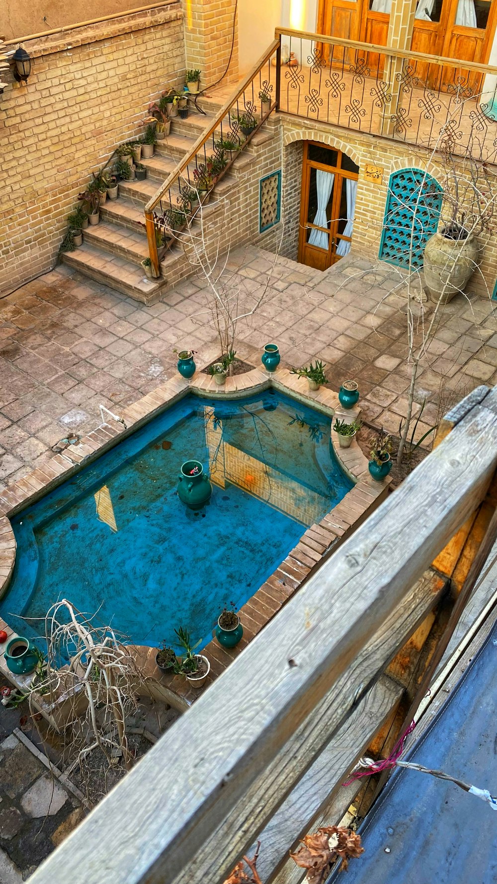 an aerial view of a pool in a courtyard