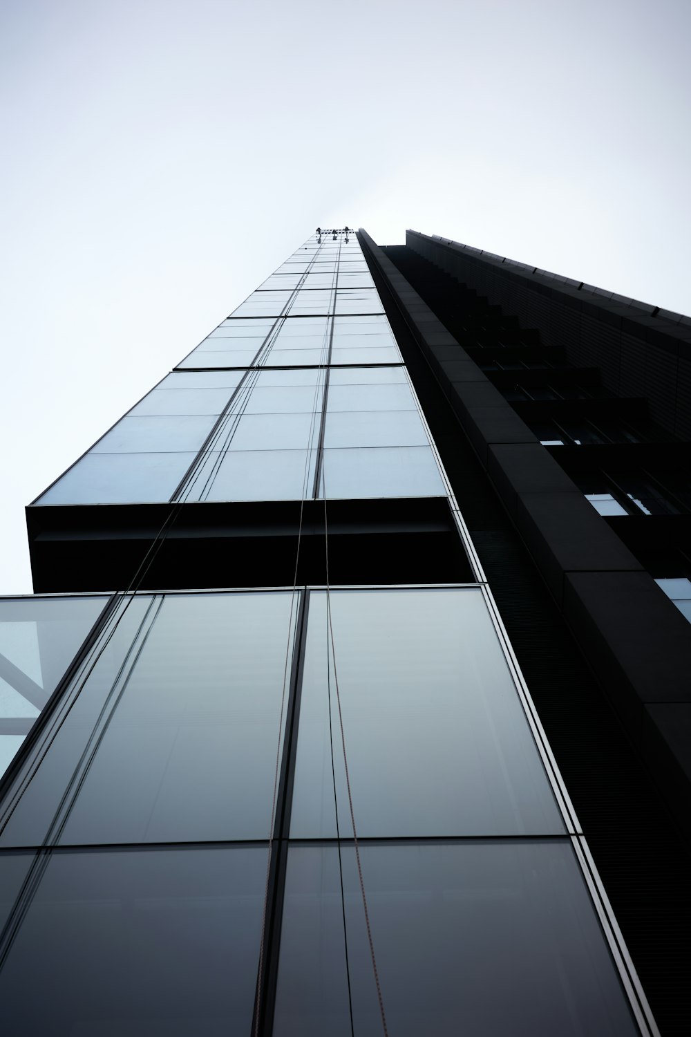 a tall glass building with a sky background