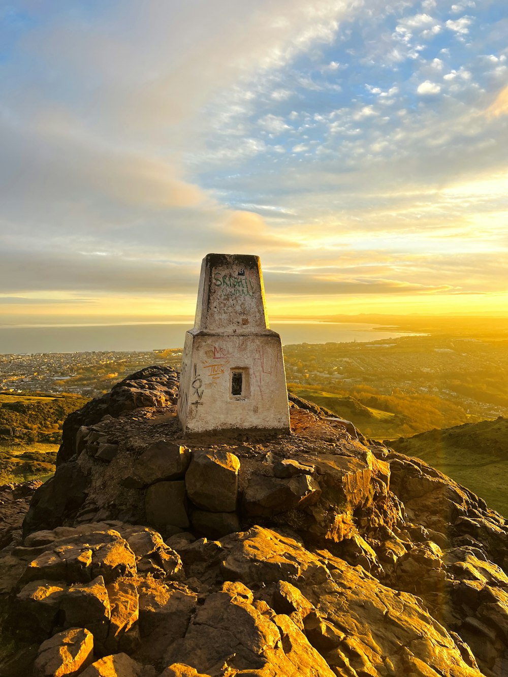 a small monument sitting on top of a rocky hill