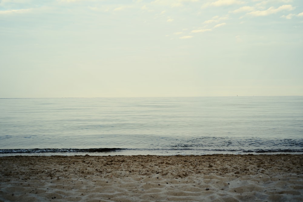 a view of the ocean from a sandy beach