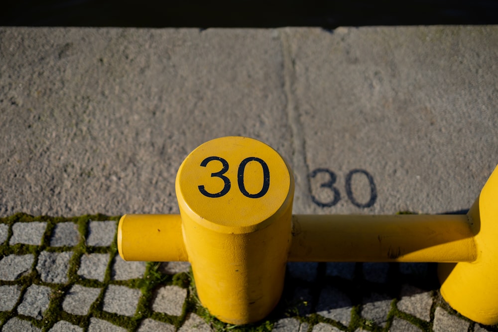 a yellow fire hydrant sitting on the side of a road