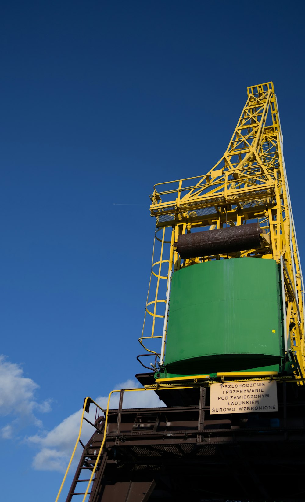 a yellow and green tower on top of a building