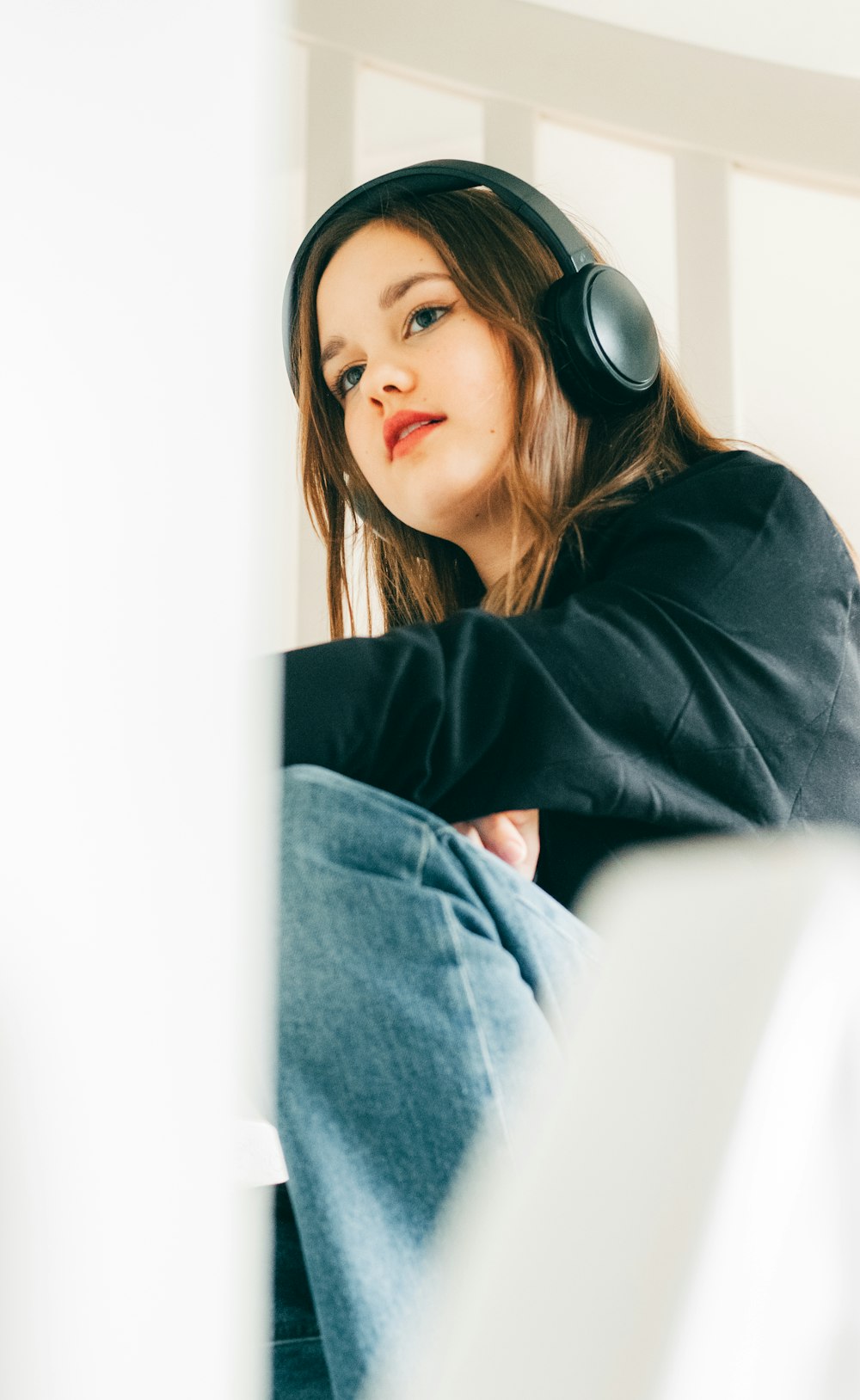 a woman sitting in a chair with headphones on