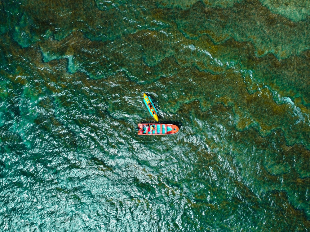 a couple of boats floating on top of a body of water