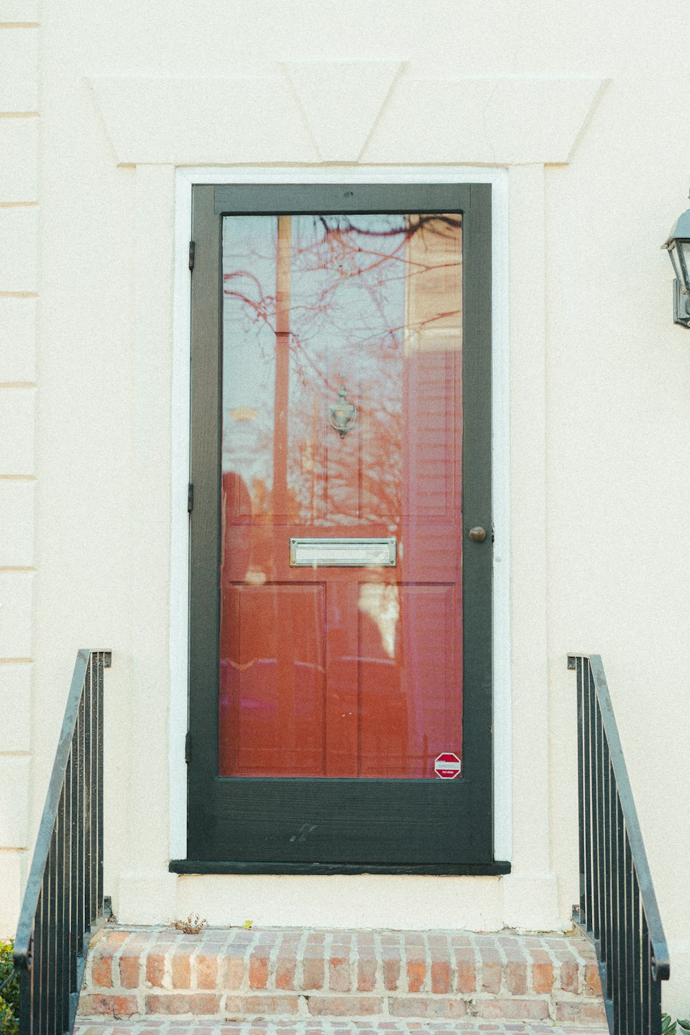 a red door and a black door on a white building