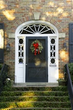 a front door with a wreath on it