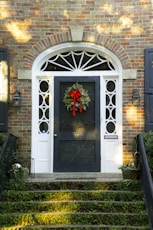 a front door with a wreath on it