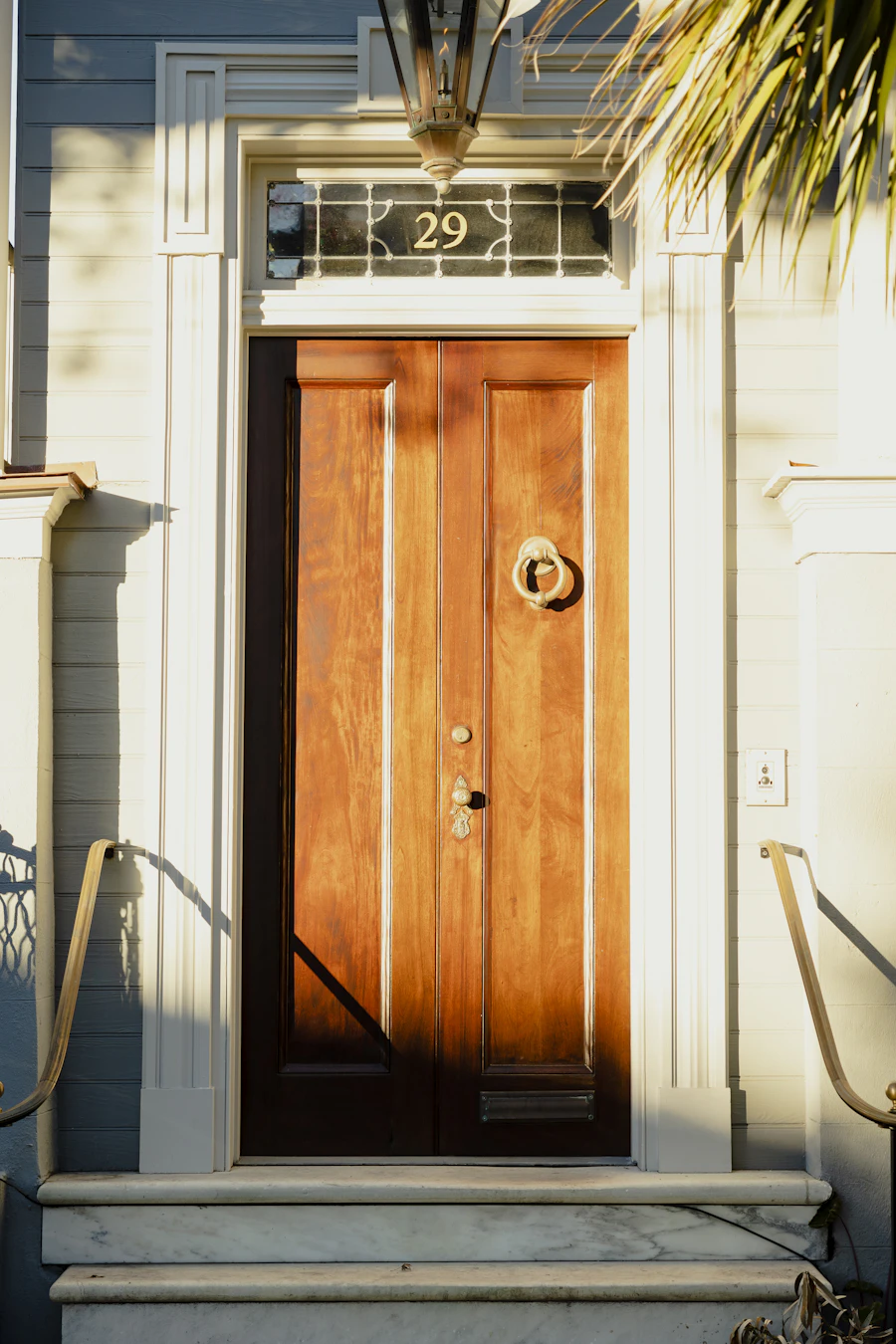 A wood front door with a fanlight