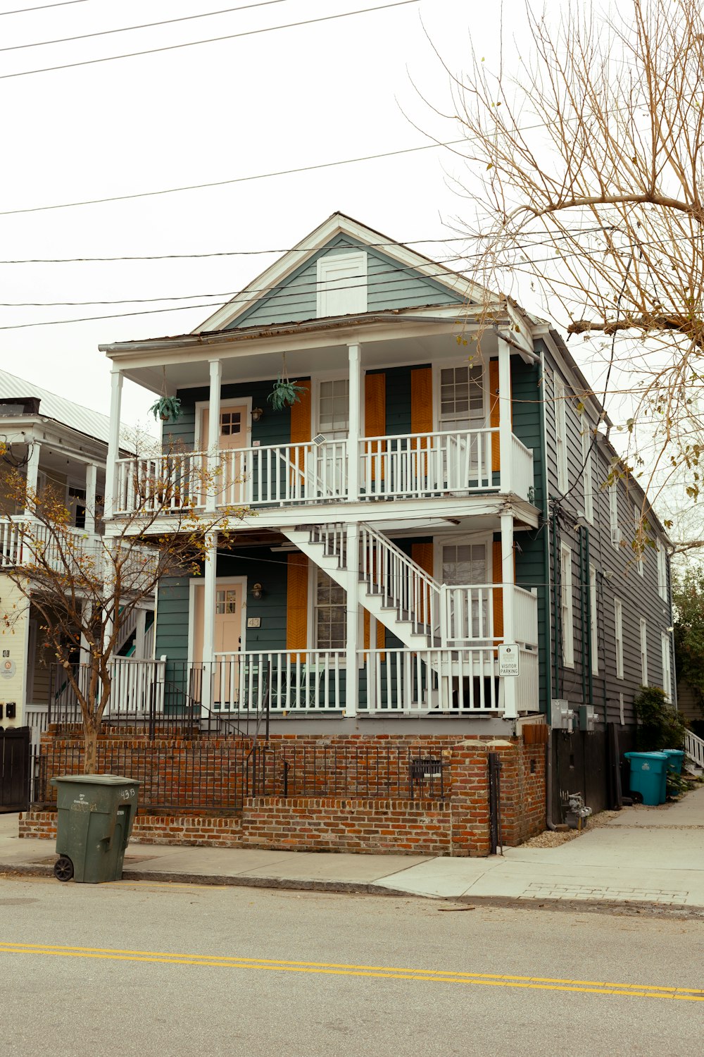 a two story house with balconies and balconies on the second story