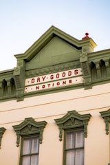 Historic building facade being restored with fresh paint and new signage.
