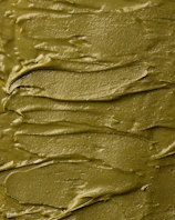 Close-up of a spoonful of vibrant green chimi gel glistening under natural light