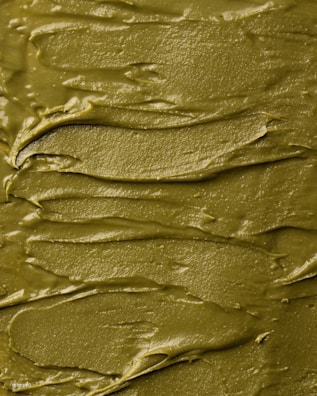 Close-up of vibrant neon green slime with glitter swirls.