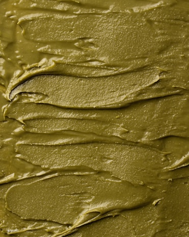 Close-up of vibrant, glossy slime in pastel pink swirls with glitter flecks catching the light.