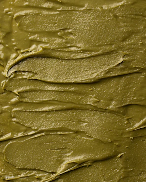 Close-up of a spoonful of vibrant green chimi gel glistening under natural light