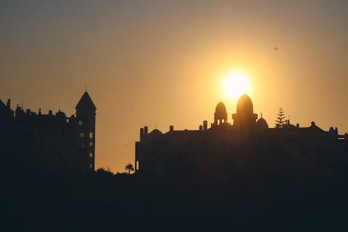 Front view of the synagogue with a warm sunset glow highlighting its entrance.