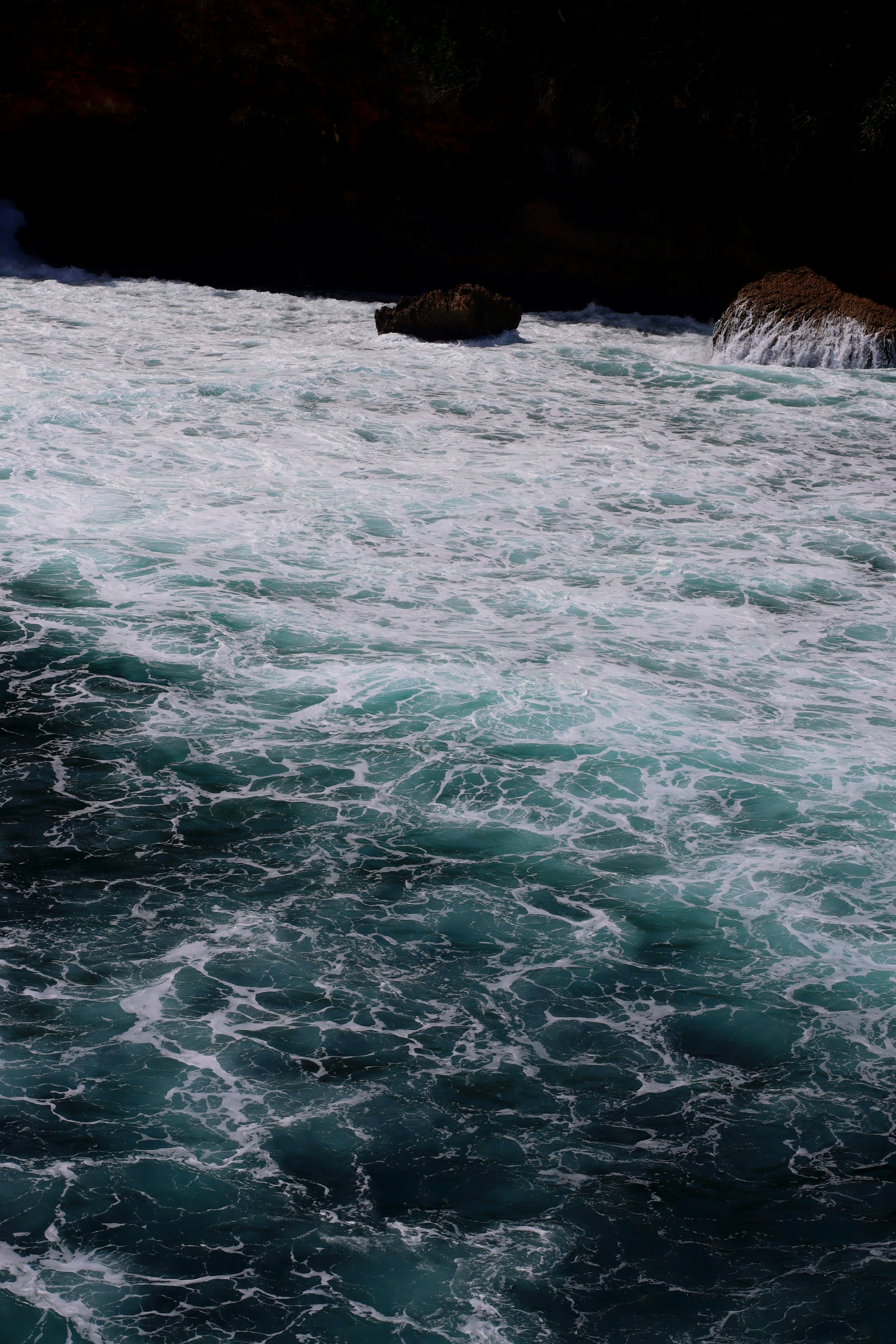 a man riding a surfboard on top of a body of water