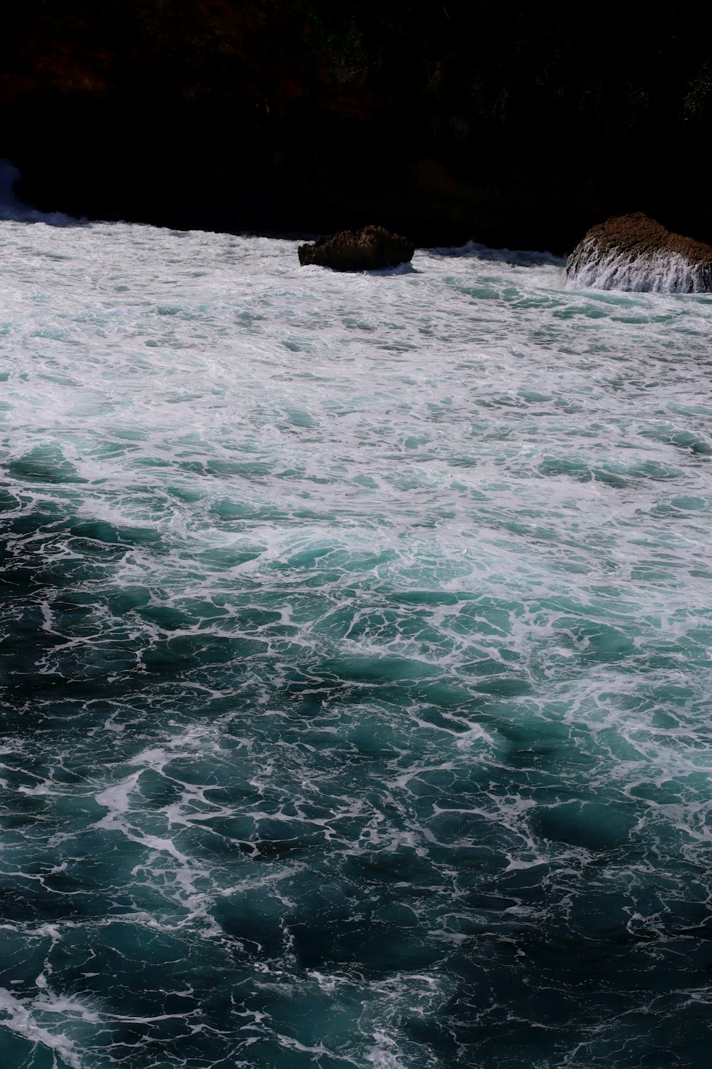 a man riding a surfboard on top of a body of water