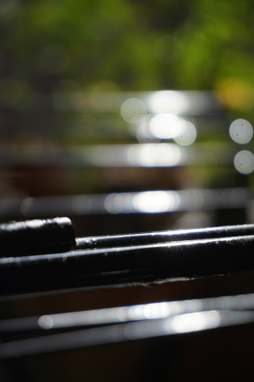 a close up of a wooden bench with a blurry background