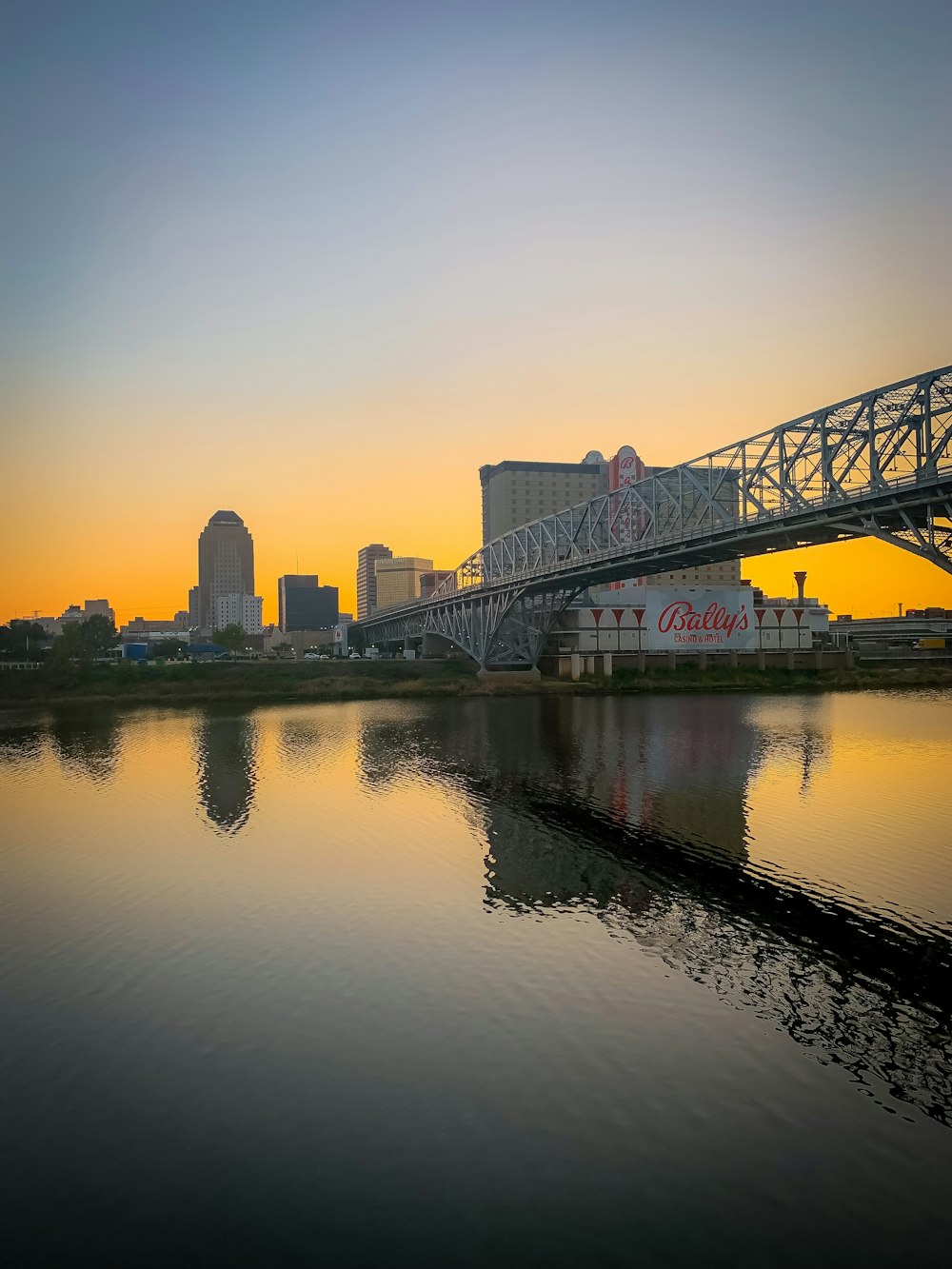 a bridge over a body of water with buildings in the background