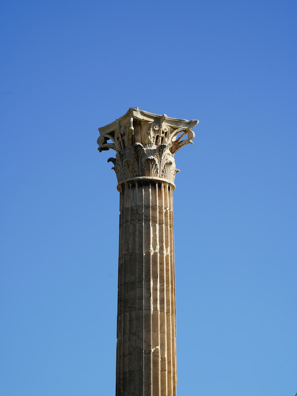 a tall pillar with a statue on top of it