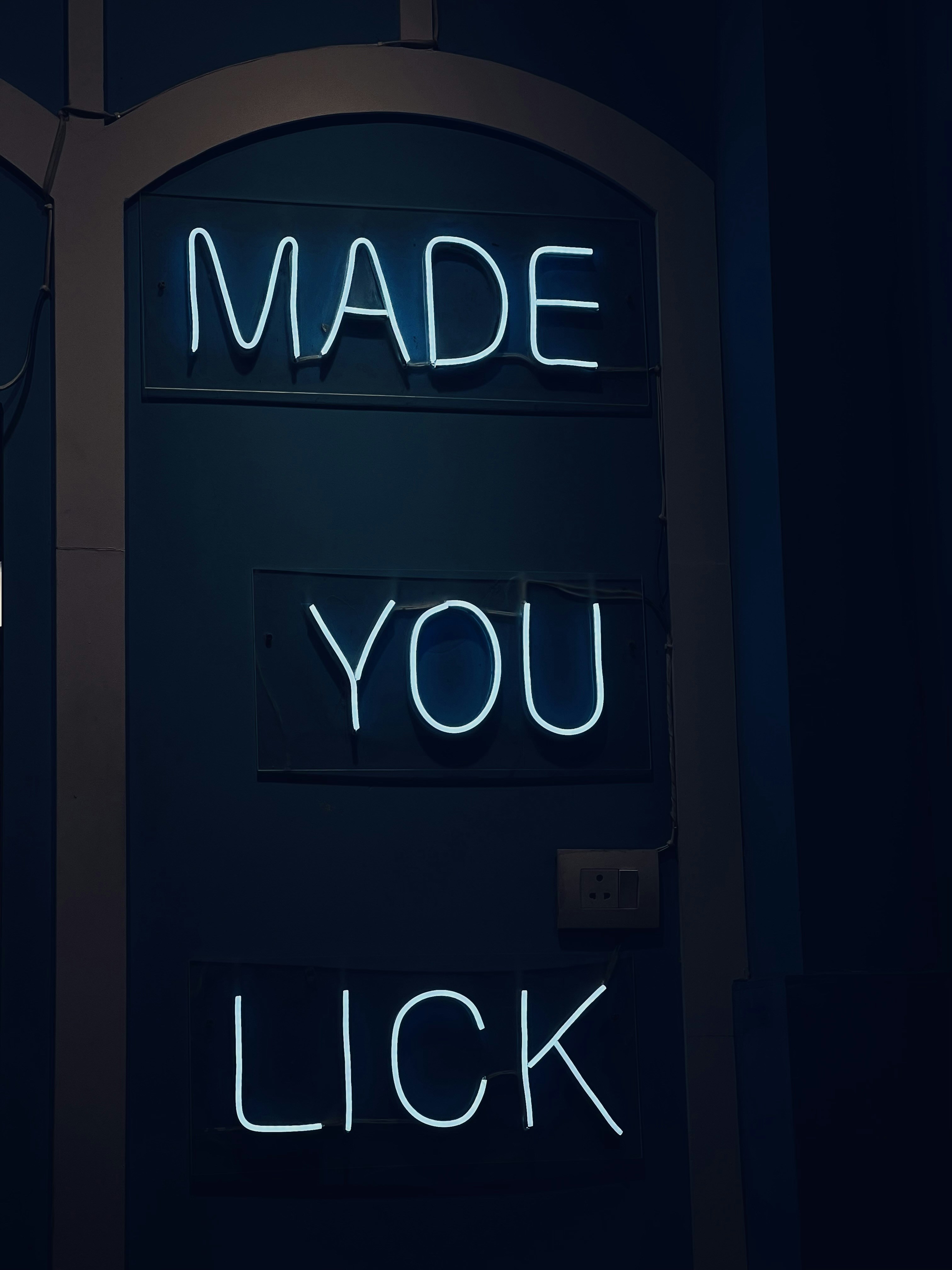 a neon sign that reads made you lick