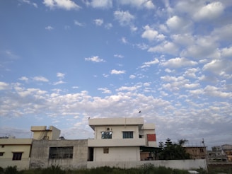 A modern residential plot with clear boundaries and greenery under a bright sky