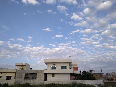 Completed residential building with greenery and clear blue sky.
