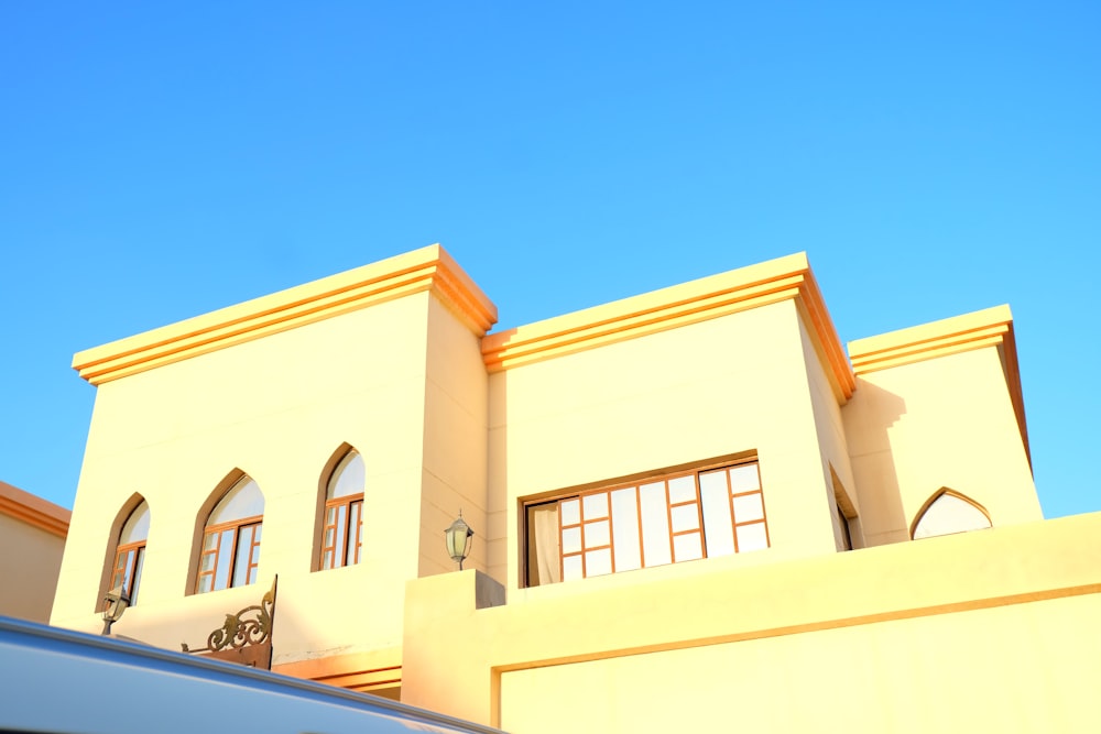 a white van parked in front of a yellow building