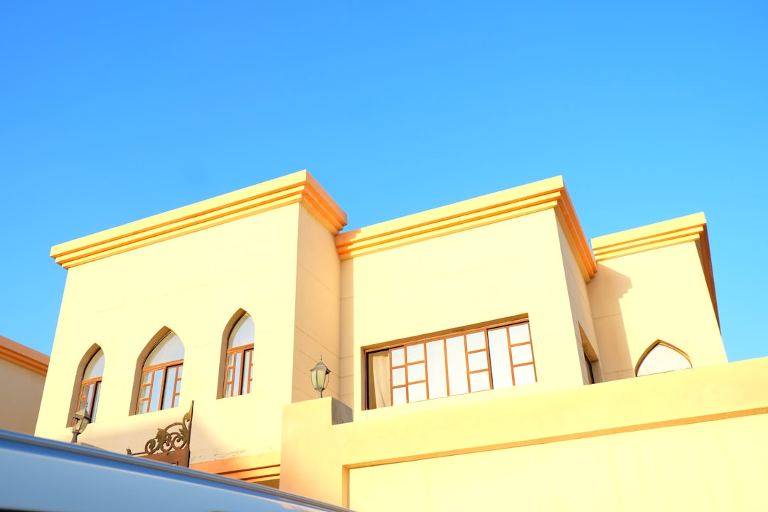 a white van parked in front of a yellow building,