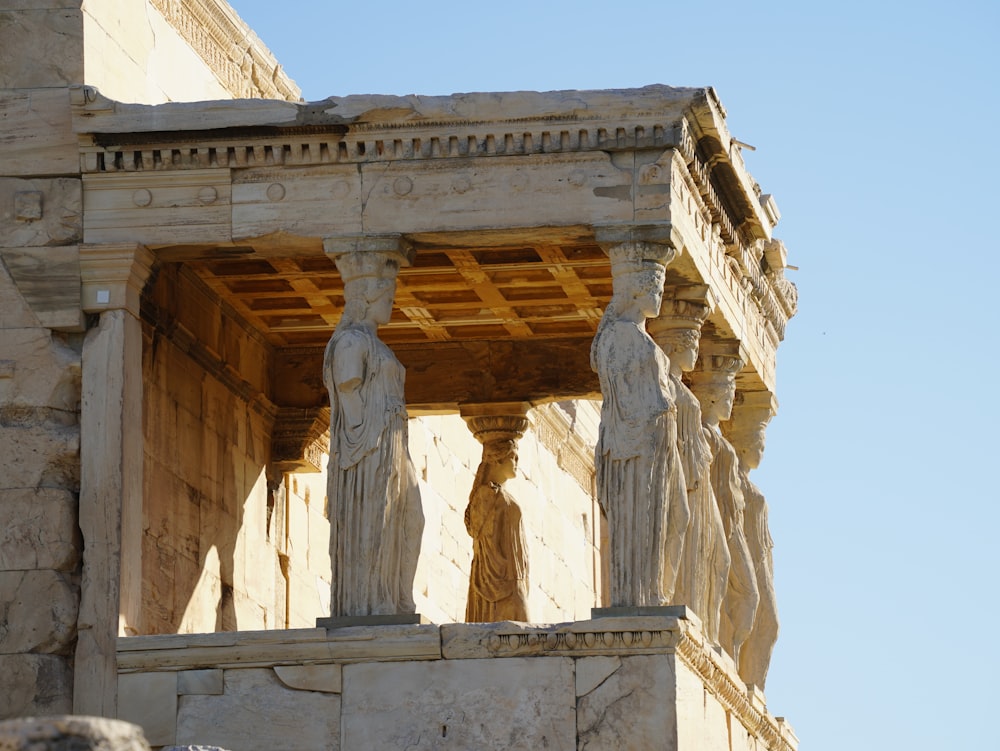 a close up of some statues on a building