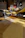 Smiling man rolling fresh pasta dough in a cozy kitchen setting