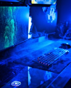 A modern desktop computer setup with dual monitors and colorful LED lighting.