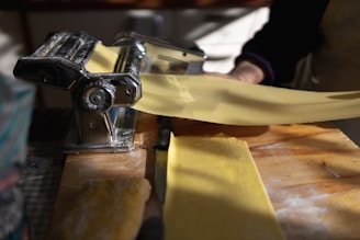 a person using a pasta cutter on a piece of yellow paper