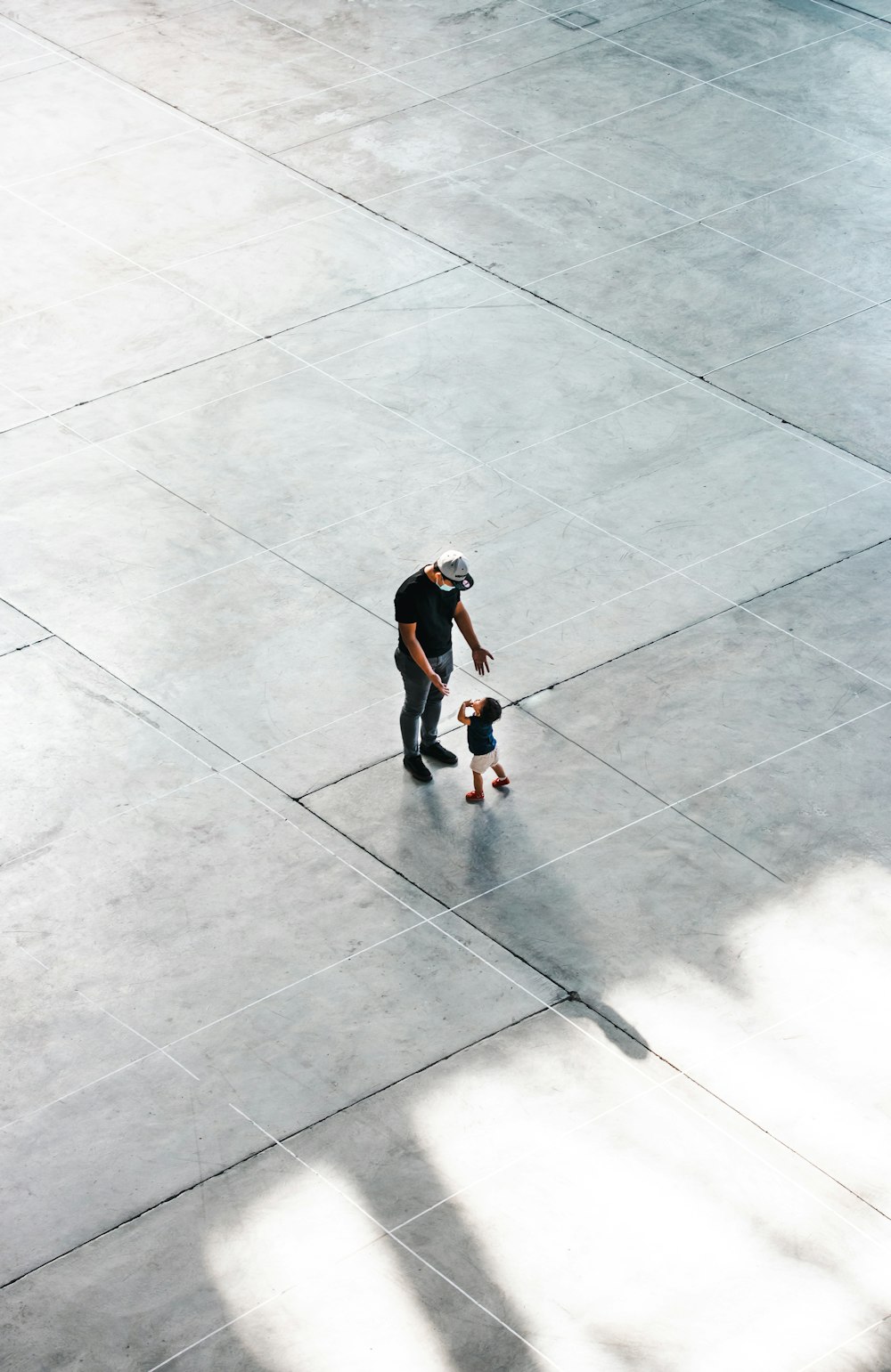 a man riding a skateboard down a cement walkway