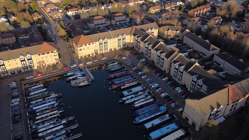 a marina filled with lots of boats next to tall buildings